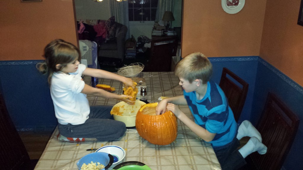 Timmy and Nora playing with pumpkin guts