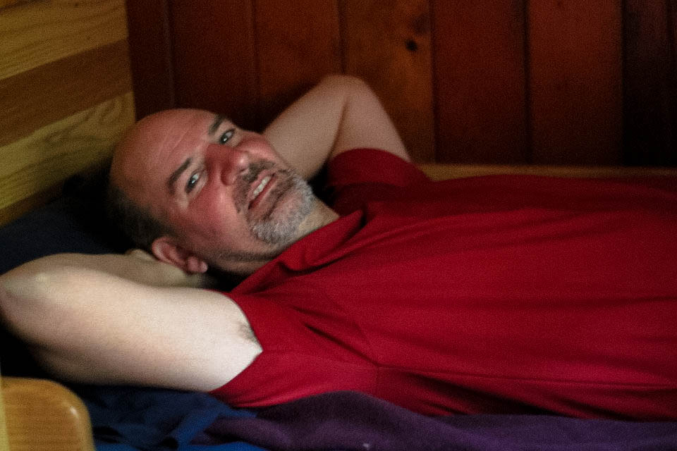 Tim relaxing in his bunk before breakfast at Mizpah.