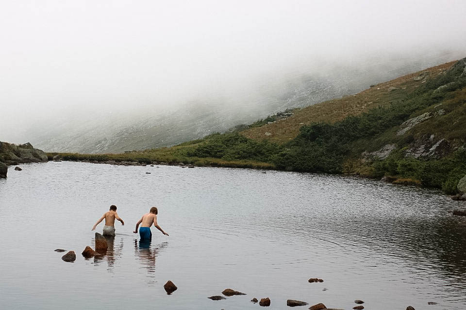 Tim and Stephen swimming in a lake on a mountain.